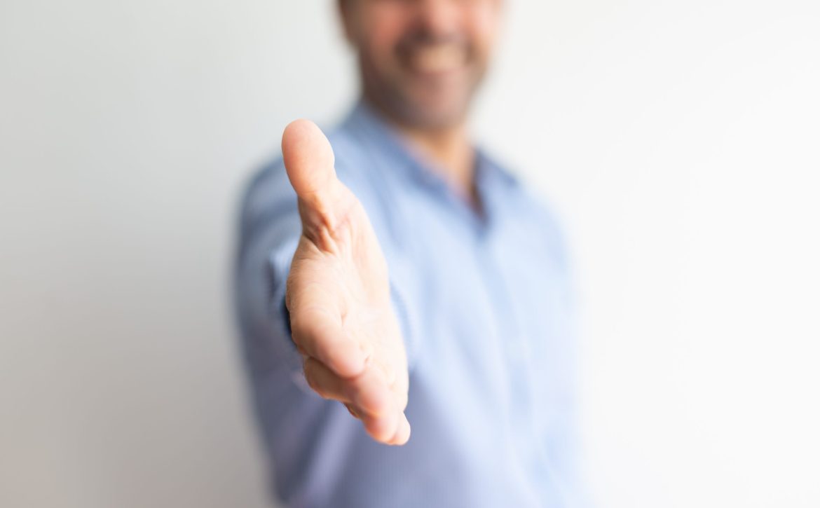 Closeup of business man offering hand for handshake